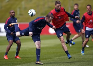England's Rooney challenges Cahill during a soccer training session at the St George's Park training complex near Burton Upon Trent