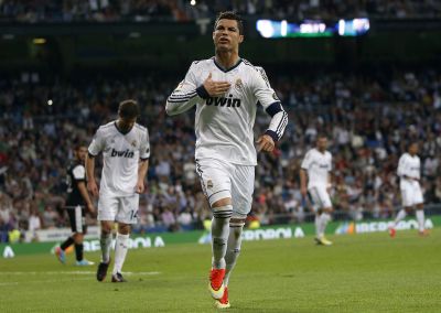 Real Madrid's Cristiano Ronaldo celebrates his goal against Malaga during their Spanish first division soccer match at Santiago Bernabeu stadium in Madrid
